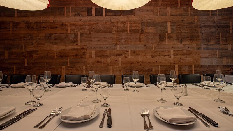 Private dining room with set table for eighteen